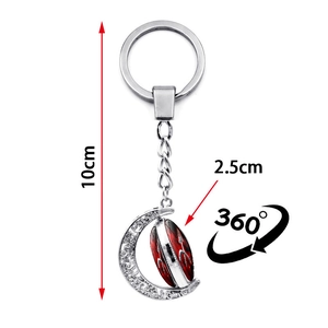 Glow-in-the-dark red zodiac keychain with a crescent moon pendant and rotating glass sphere