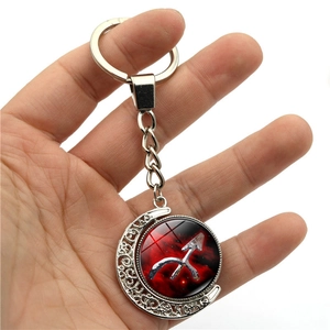 Luminous Sagittarius constellation keychain with rotating red nebula glass ball and silver moon