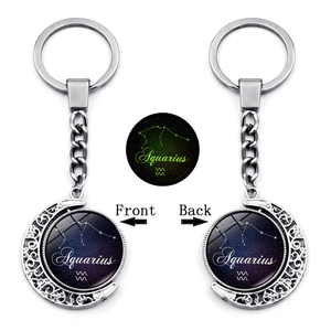 Luminous Aquarius constellation keychain featuring a rotating moon-shaped metal pendant