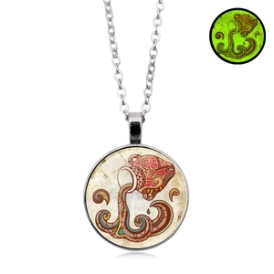 Close-up of Aquarius zodiac necklace with luminous green glow effect in the dark