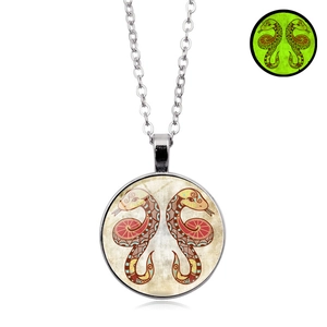 Glow in the dark glass pendant necklace featuring hand-painted snakes with green fluorescence