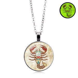 Detailed close-up of Scorpio zodiac pendant showing green glow in the dark effect