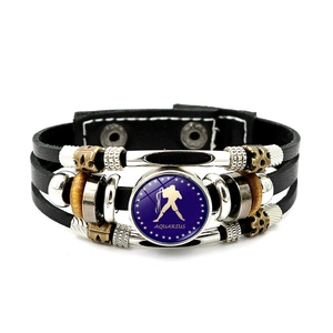 Macro shot of Aquarius constellation charm on multilayer vintage leather bracelet