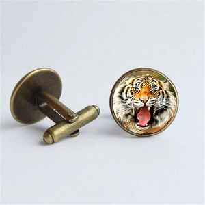 Macro view of vintage bronze tiger head cufflinks for men with detailed roaring animal pattern