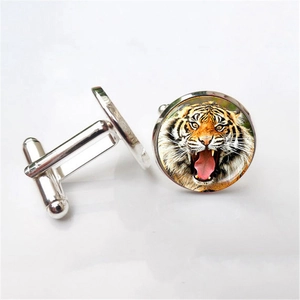 Detailed macro view of men's silver cufflinks featuring a colorful roaring tiger design