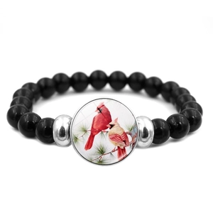 Beaded cardinal bird bracelet featuring black stones and silver accents on white background