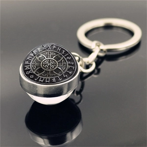 Macro detail of Viking Vegvisir compass and runes under spherical glass crystal