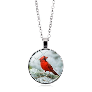 Detailed view of cardinal bird glass cabochon pendant with silver metal chain