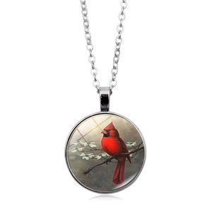 Silver cardinal bird necklace with round glass pendant showing bird on flower branch