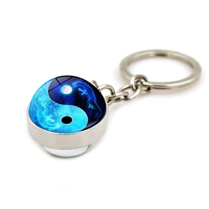 Yin Yang glass cabochon keychain with dragon motif and silver-tone metal keyring