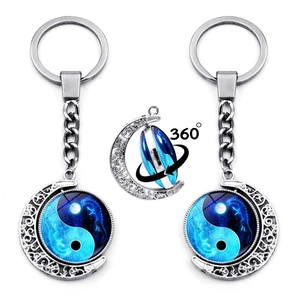 Silver lunar keychain with rotating Yin Yang dragon charm and 360-degree spinning action