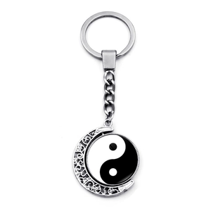 Rotating Yin Yang Tai Chi moon pendant keychain with intricate silver filigree details