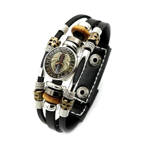 Macro detail of Viking leather bracelet with engraved sword pendant and Runic symbols
