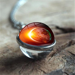 Détail macro du pendentif globe en verre éclipse avec chaîne en argent vintage