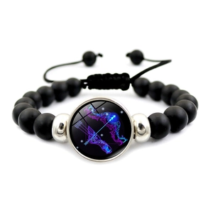 Handmade Sagittarius constellation bracelet with matte black beads and neon zodiac pendant
