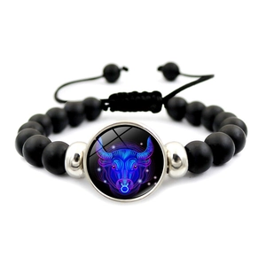 Detail of Taurus zodiac bracelet with matte black beads and adjustable cord