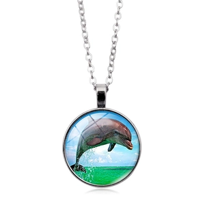 Dettaglio della collana con ciondolo delfino in argento e motivo oceano in vetro