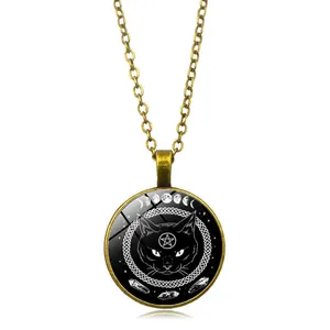 Detail of vintage bronze necklace featuring black cat and pentagram glass dome pendant