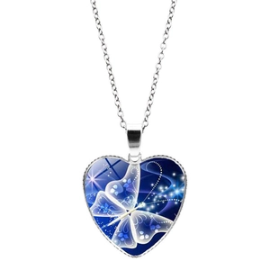 Detailed close-up of heart-shaped pendant with blue butterfly pattern and silver chain