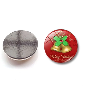 Detail of Christmas glass fridge magnets featuring golden bells and magnetic back