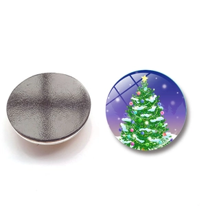 Close-up of glass Christmas magnet featuring a festive tree design and magnetic back