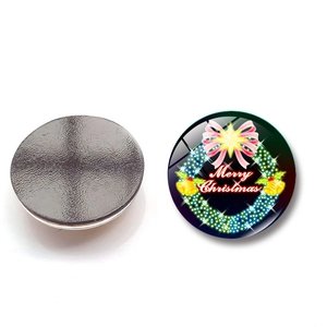 Detail showing front floral Christmas wreath design and black magnetic back of the 30mm glass sticker