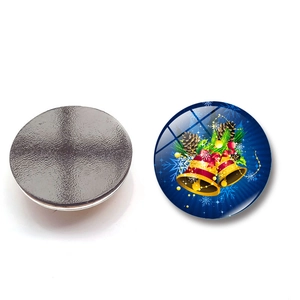 Detail of 30mm Christmas glass fridge magnet showing magnetic back and festive bell design