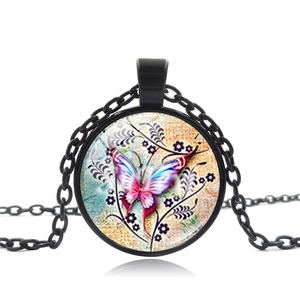 Detail of vintage butterfly time gem pendant with black metal chain and floral background