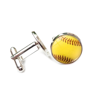 Détail de boutons de manchette argentés pour hommes avec motif softball jaune et coutures rouges