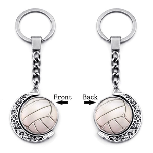 Front and back views of a 360-degree rotating silver volleyball moon keychain charm