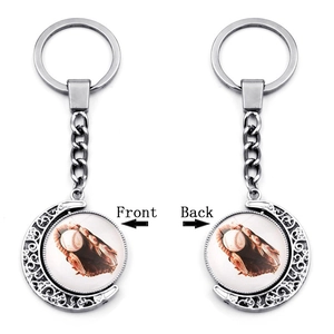 Rotating silver moon keychain with double-sided baseball glass cabochon detailing