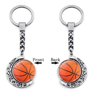 Rotating basketball keychain with silver crescent moon pendant and double-sided glass dome