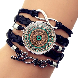 Detail of multi-layer leather bracelet with infinity symbol and mandala glass charm
