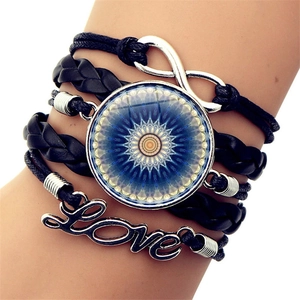 Close-up of multilayer leather bracelet with infinity symbol and Love charm