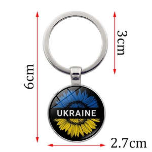 Ukraine sunflower glass cabochon keychain with blue and yellow flag colors on white background