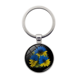 Silver keyring with sunflower glass cabochon pendant in blue and yellow colors