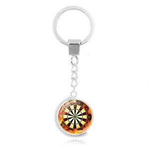 Detail of metal rotating dartboard keychain with orange fire pattern and beaded edge