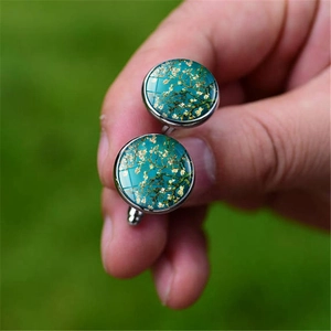 Macro detail of silver cufflinks featuring Van Gogh Almond Blossoms art inlay