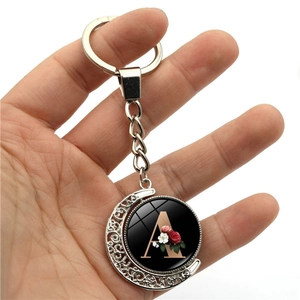 Rotating moon keychain with metal frame and double-sided floral letter A pendant