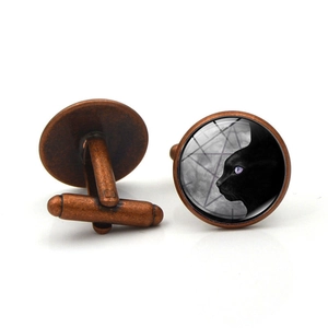 Vintage bronze cufflinks featuring a black cat silhouette under the moon under glass dome