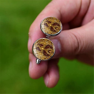 Golden phoenix glass gem cufflinks for men featuring a Celtic woven border and silver base