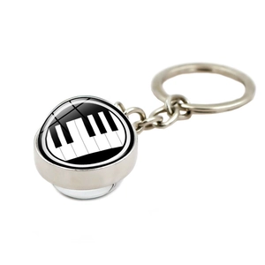 Detailed macro view of a silver piano keyboard crystal glass ball keychain with metal ring