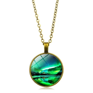 Detailed close-up of a bronze northern lights pendant with glass dome and mountain design