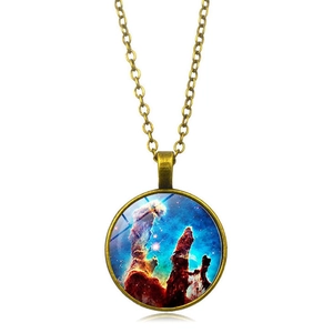 Macro detail of Pillars of Creation nebula under glass cabochon in bronze pendant