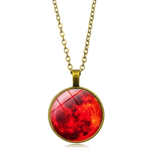 Detail of vintage bronze pendant with red moon glass dome and nebula art on metal chain