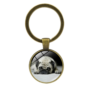 Detail of bronze pug puppy photo keychain with glass dome and metal split ring