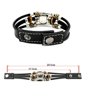 Detail view of pug dog leather bracelet with adjustable snaps and layered beads