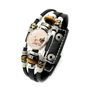 Detailed view of multilayer leather bracelet featuring a cute pug illustration charm