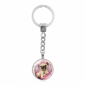 Close-up of a silver round keychain featuring a cute pug illustration with pink flowers