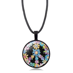 Macro detail of bohemian glass dome pendant necklace with colorful floral patterns
